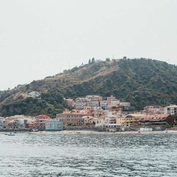 a large body of water with a city in the background