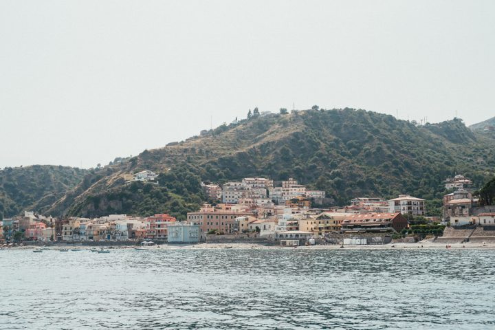 a large body of water with a city in the background