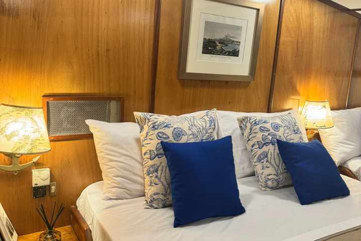 a bedroom with a bed and a chair in a room