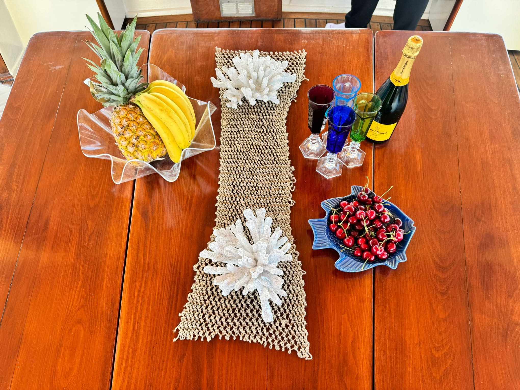 a vase of flowers sitting on top of a wooden table