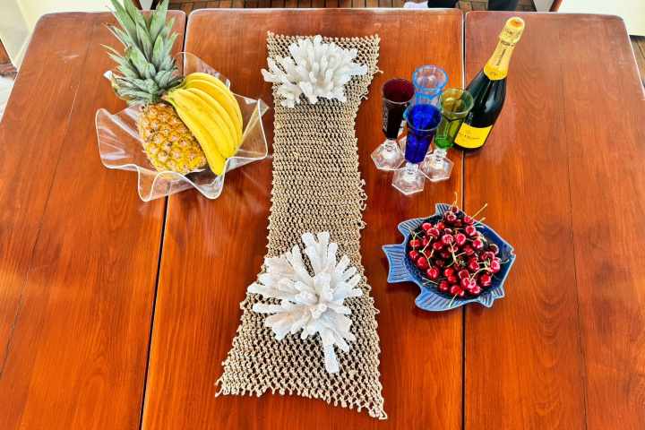 a vase of flowers sitting on top of a wooden table