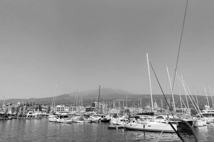 a boat is docked next to a body of water