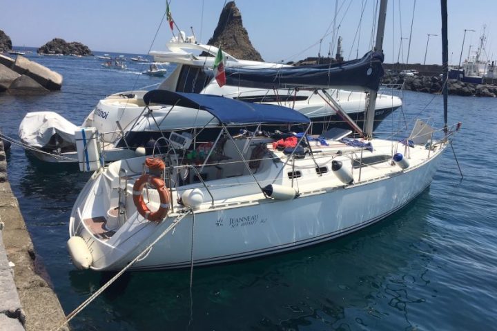 a close up of a boat next to a body of water