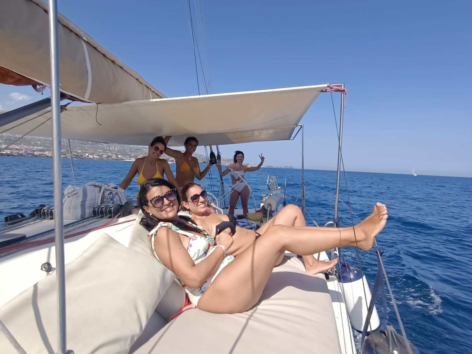 a person standing in front of a boat next to a body of water