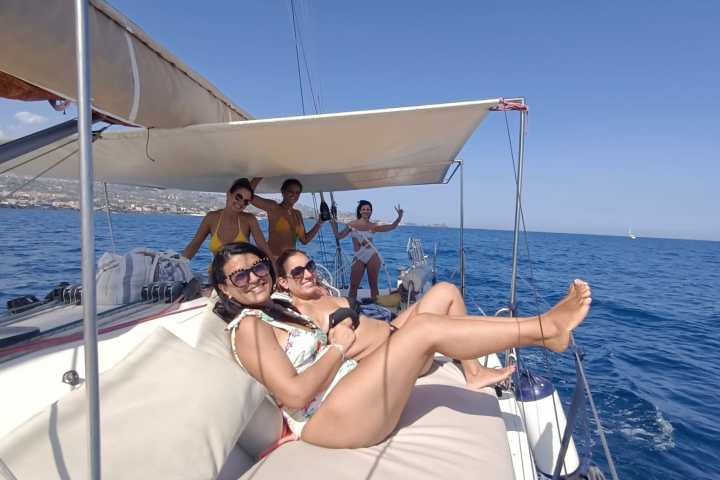 a person standing in front of a boat next to a body of water