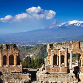 a castle like building with a mountain in the background