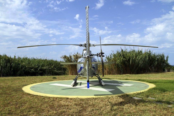 a close up of a light pole sitting in the grass