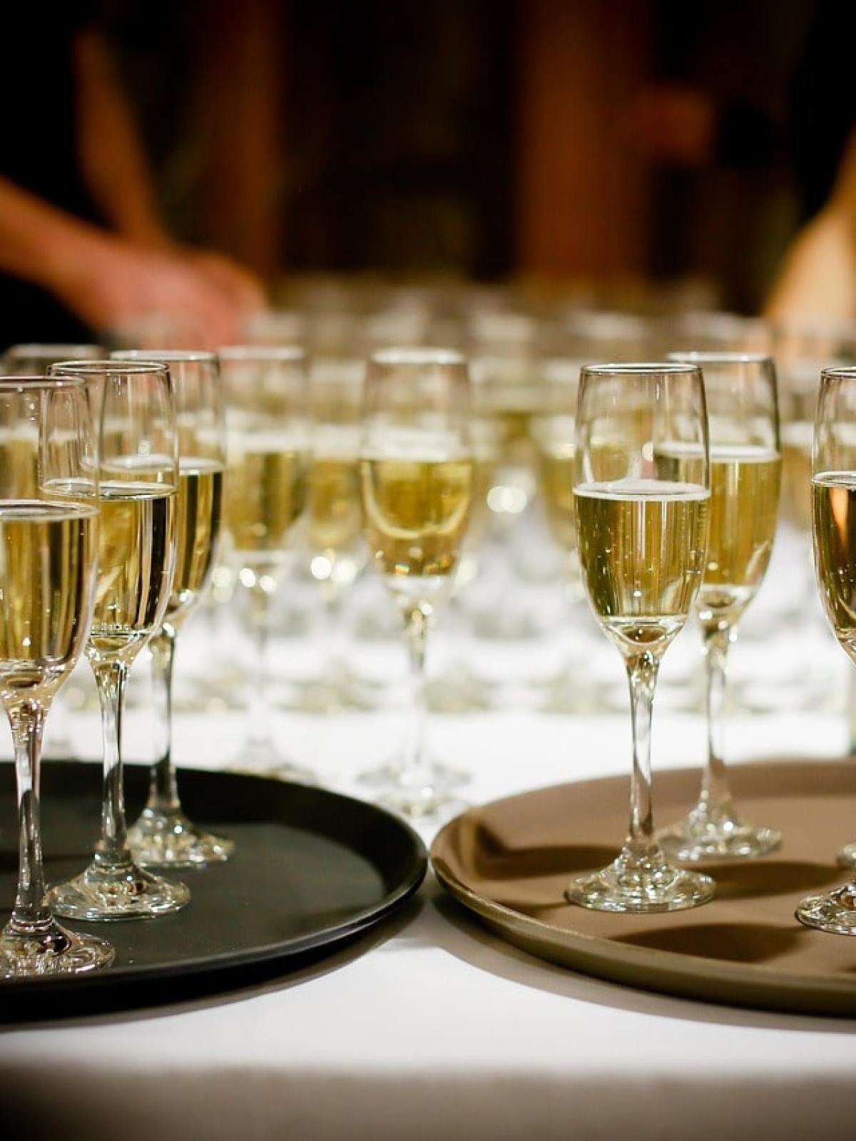 a person sitting at a table with wine glasses