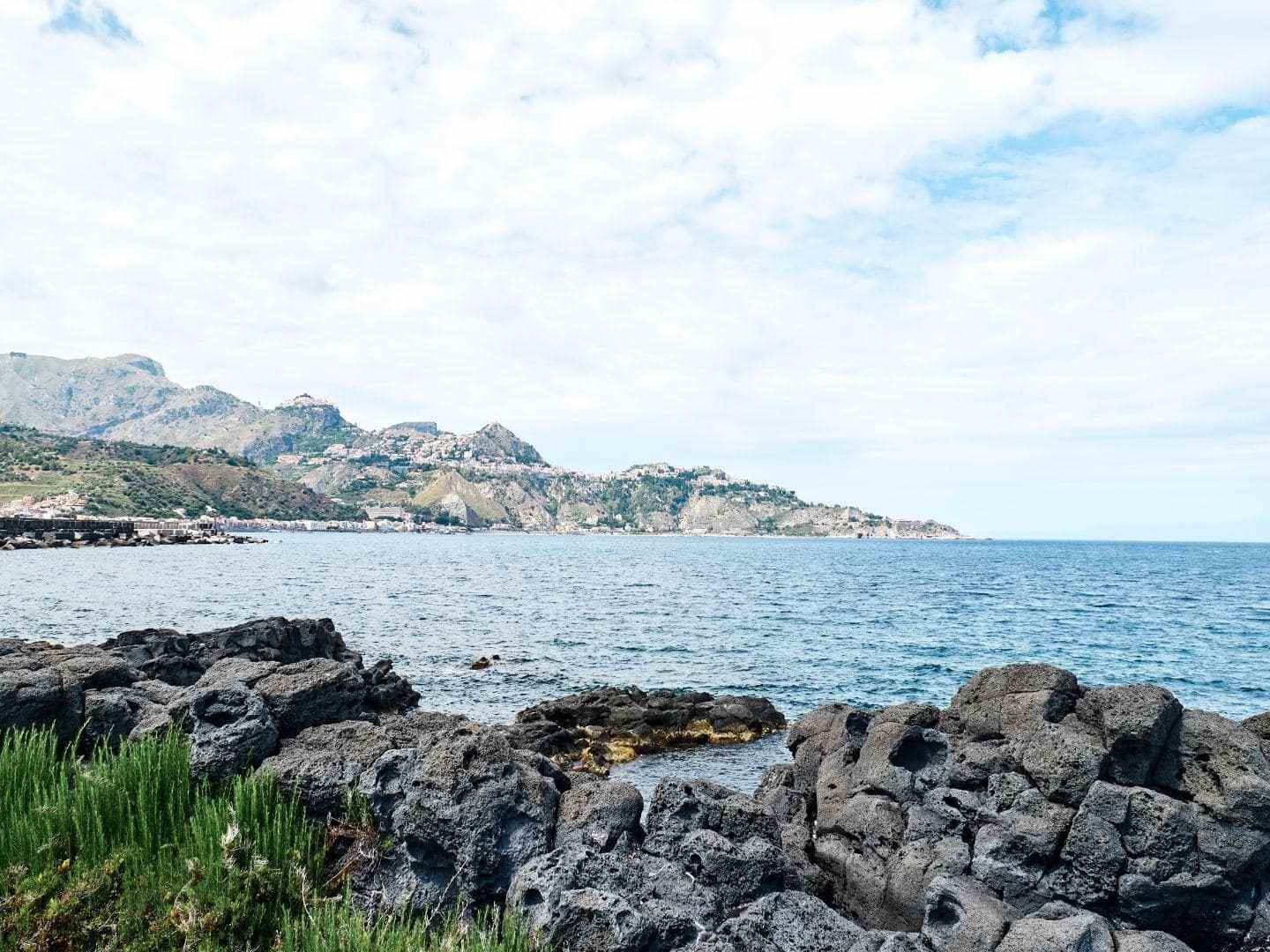 a rocky beach next to a body of water