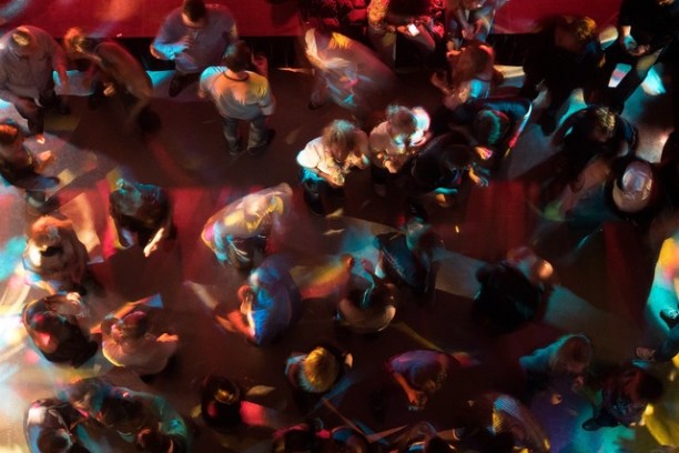 a group of people performing on stage in front of a crowd