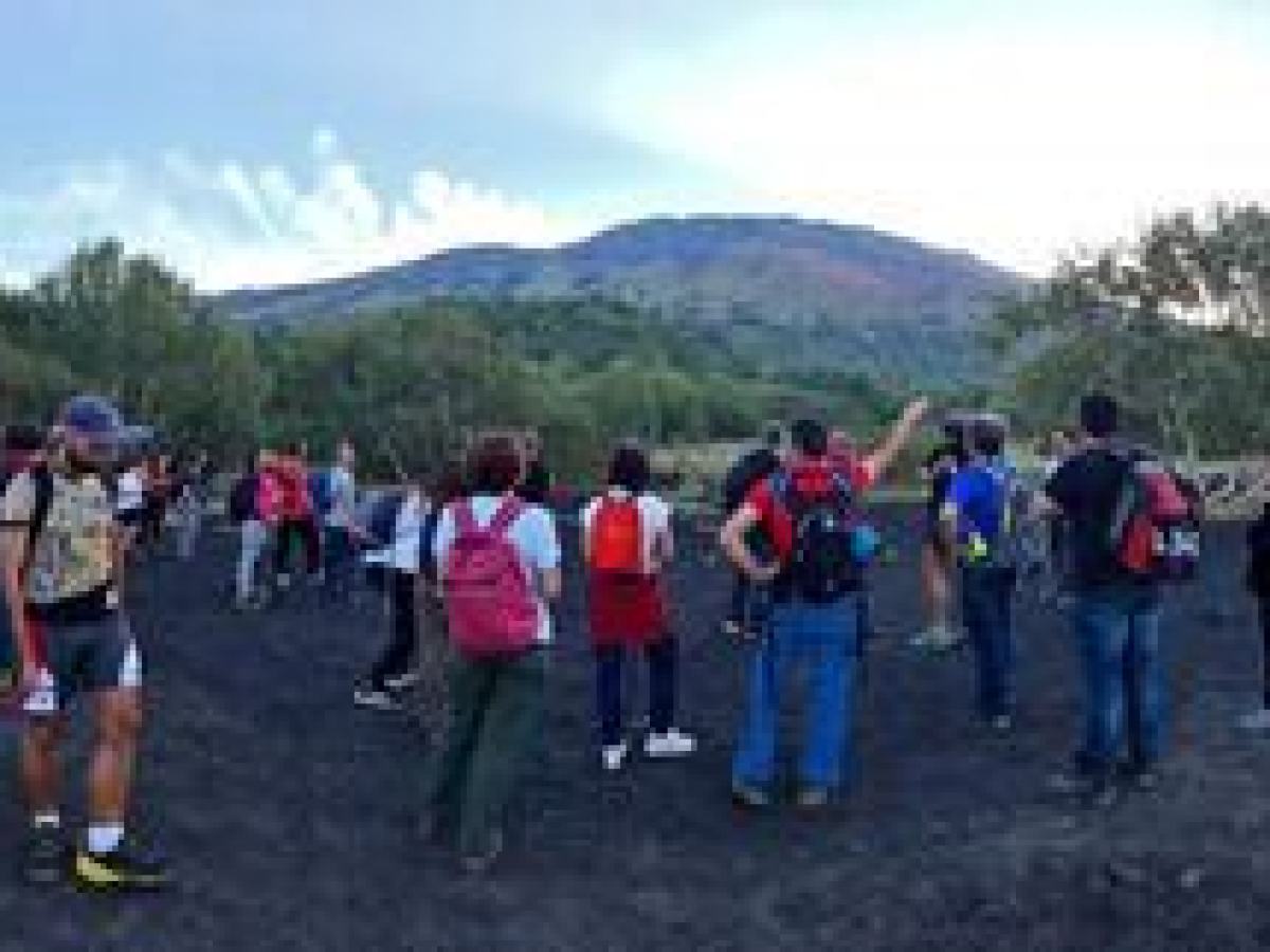 a group of people standing on top of a mountain