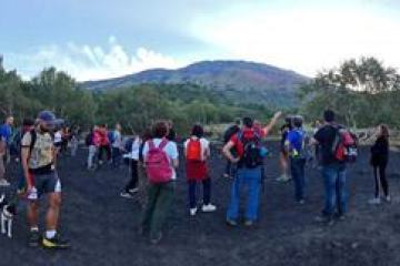 a group of people standing on top of a mountain