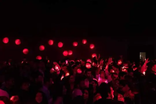 a crowd of people in a dark room