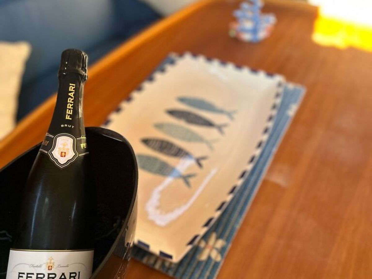 a glass of wine sitting on top of a wooden table