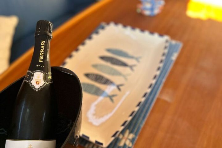 a glass of wine sitting on top of a wooden table