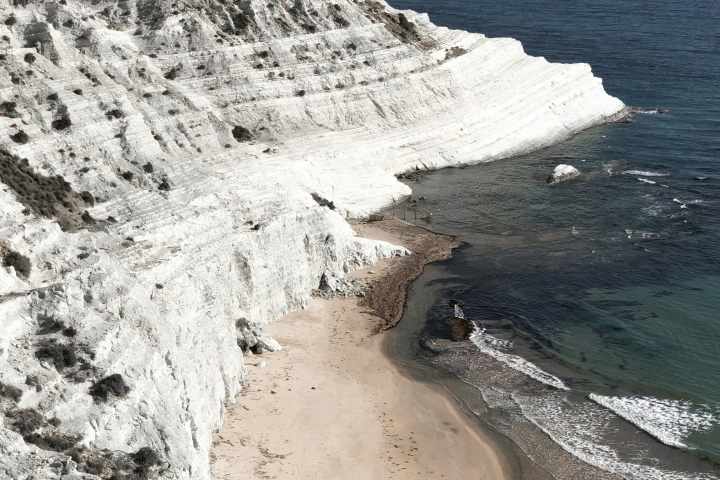a body of water with a mountain in the background