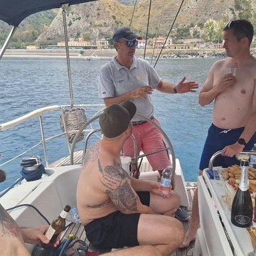 a couple of people that are drinking water from a boat