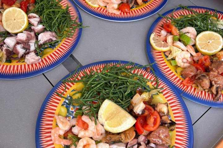 a plate sea food on a boat table in Catania