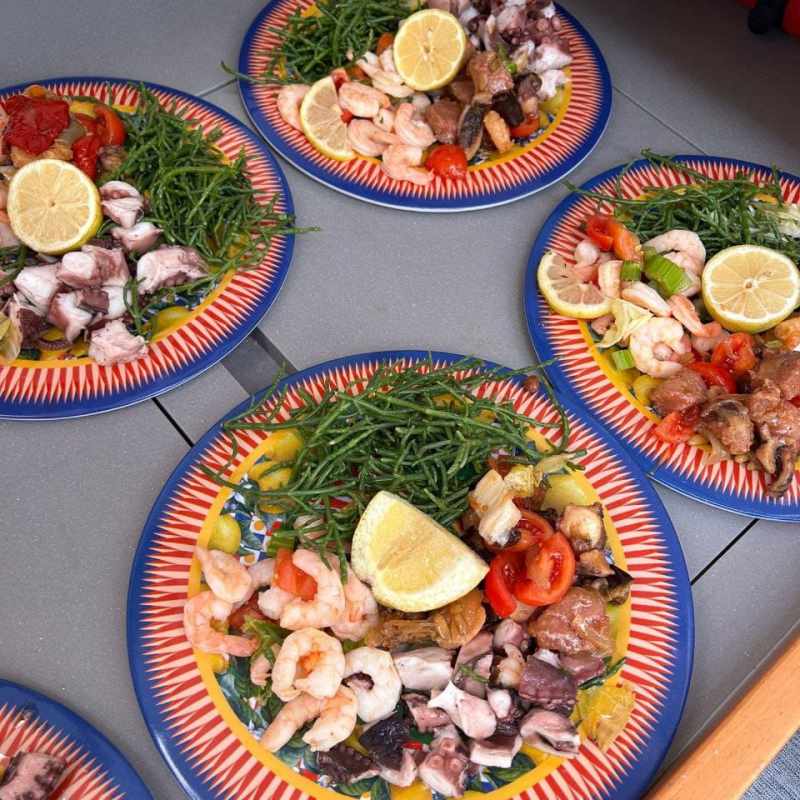 a plate sea food on a boat table in Catania