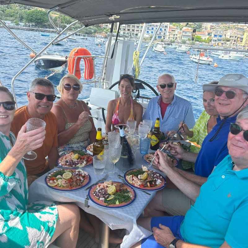 a group of people sitting at a table eating food