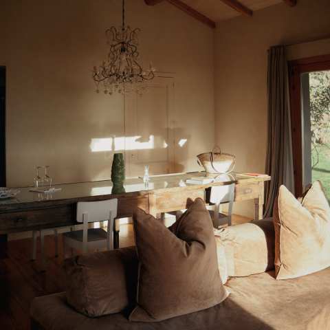 a living room with a bed and looking at the camera