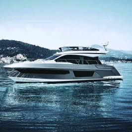 A luxury yacht sailing on calm waters with hills in the background.