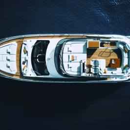 Overhead view of a luxury yacht on a dark blue sea.