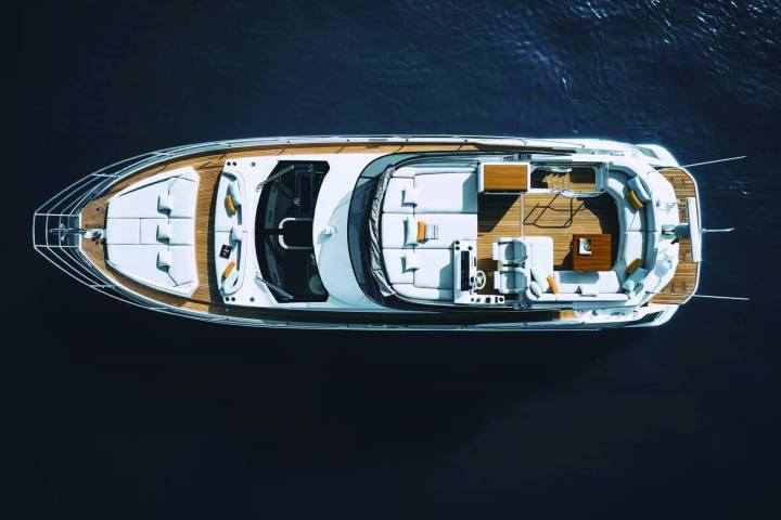 Overhead view of a luxury yacht on a dark blue sea.