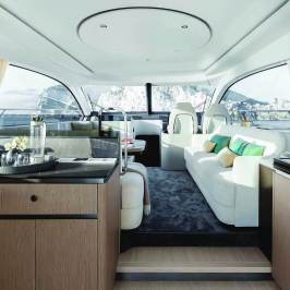 Luxurious yacht interior with modern furnishings and large windows.